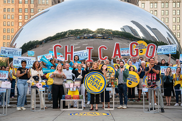 students standing in front of large bean shaped sculpture with mirrored finish in Millennium park